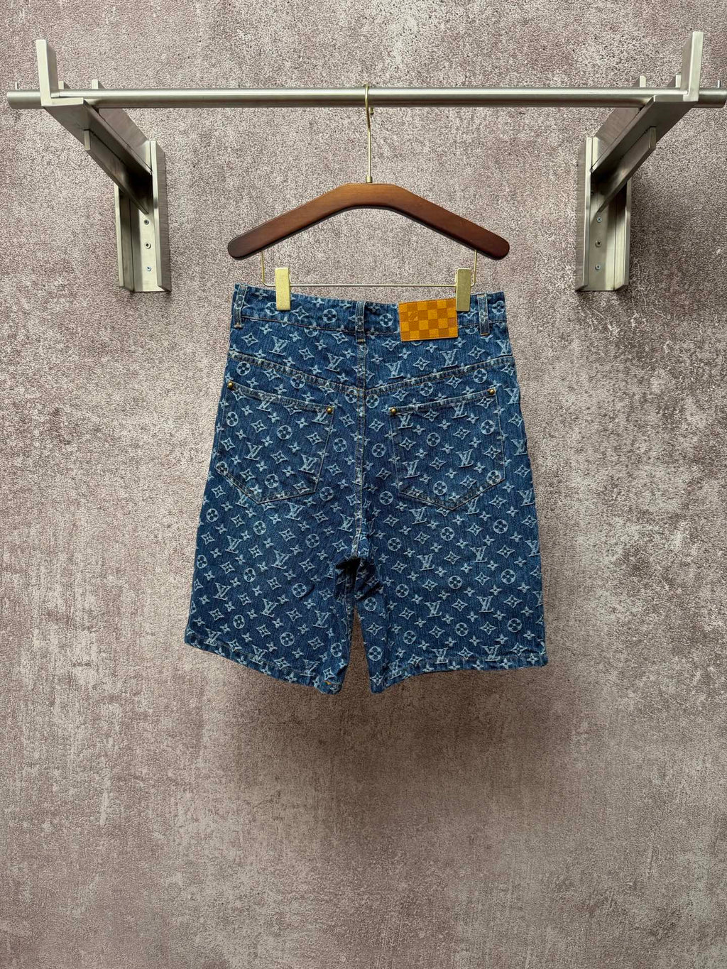 Louis Vuitton monogram denim shorts, front view with button closure