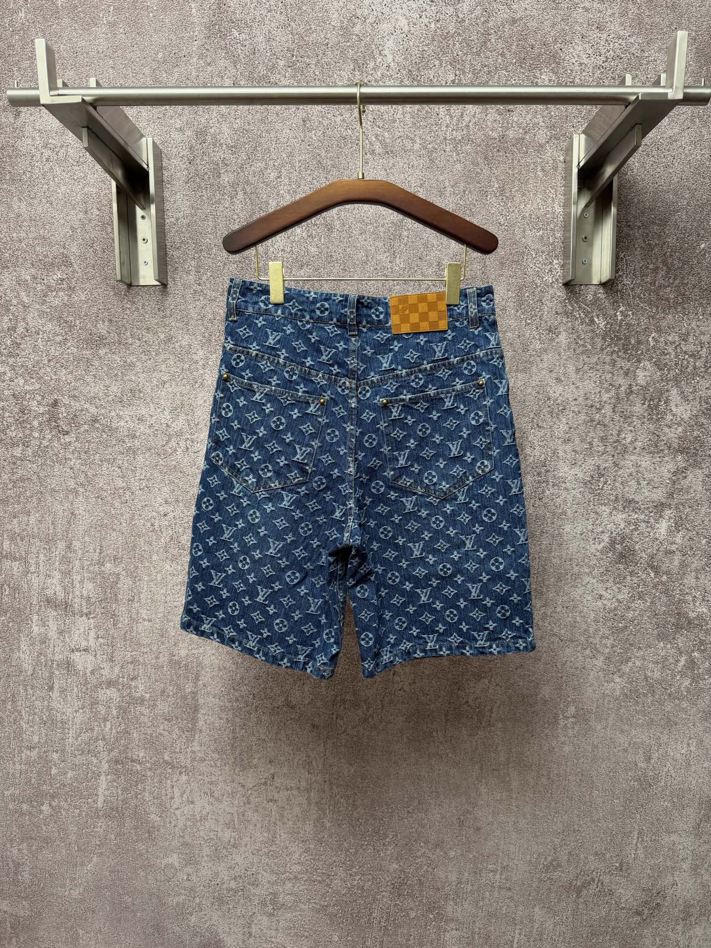 Louis Vuitton monogram denim shorts, front view with button closure