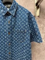 Blue monogram short-sleeve shirt with pointed collar, button front, and chest pocket