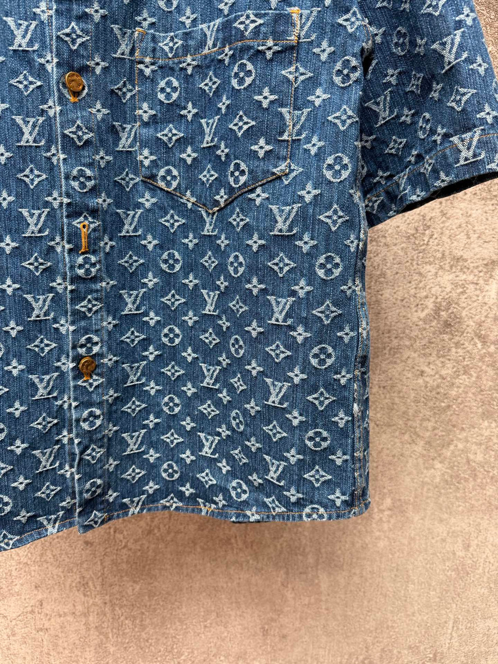 Blue patterned short-sleeve shirt with cuffed hem and gold-tone buttons at placket