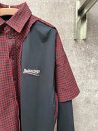 Long shirt close-up: dark gray chest panel with Balenciaga logo, check collar