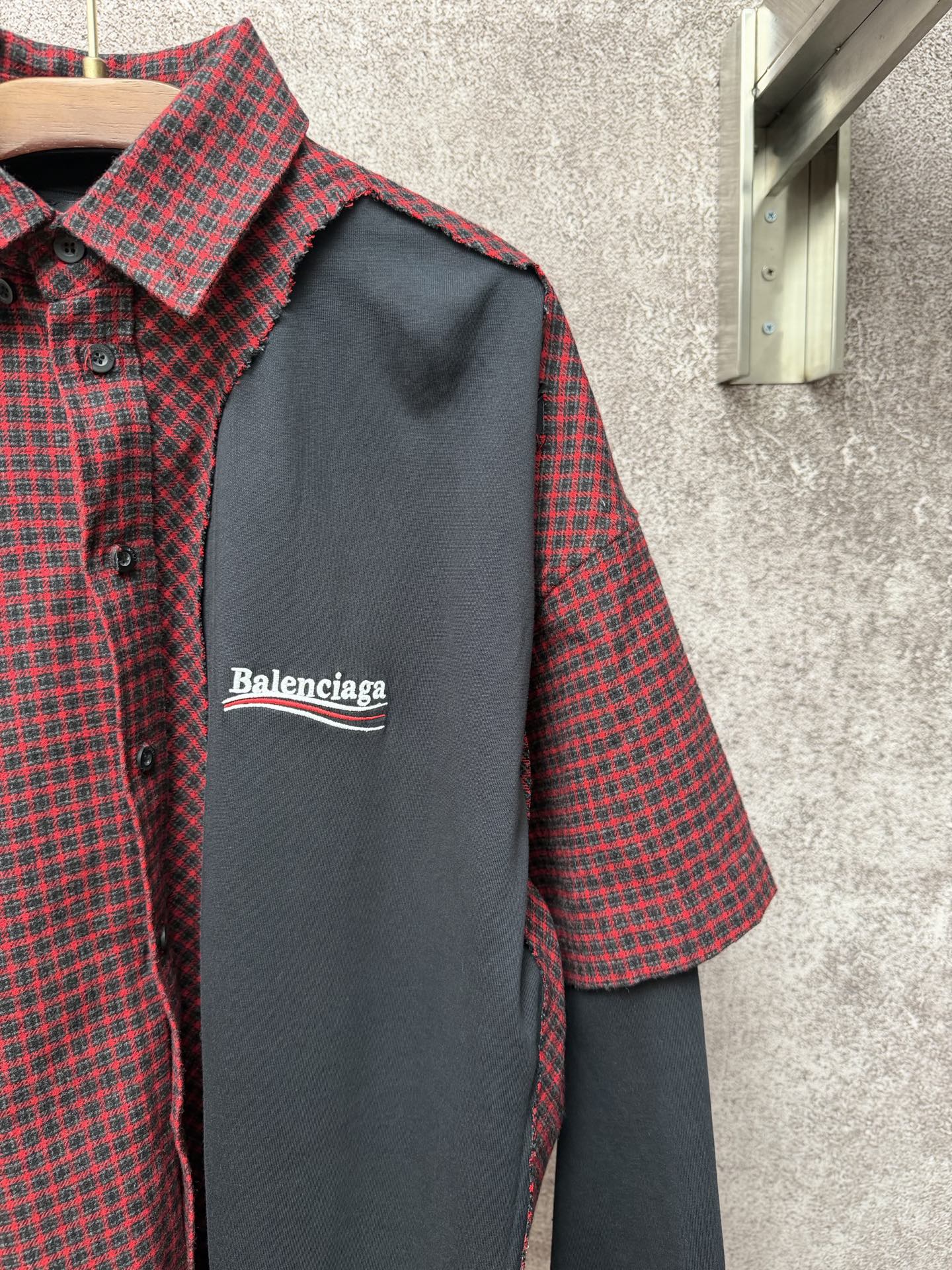Long shirt close-up: dark gray chest panel with Balenciaga logo, check collar