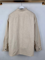 Beige long-sleeve button-up shirt back view with center seams and buttons
