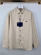 Beige long-sleeve button-up shirt with point collar and chest pocket