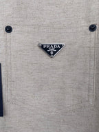 Beige shirt chest pocket with PRADA logo triangle patch and two buttons