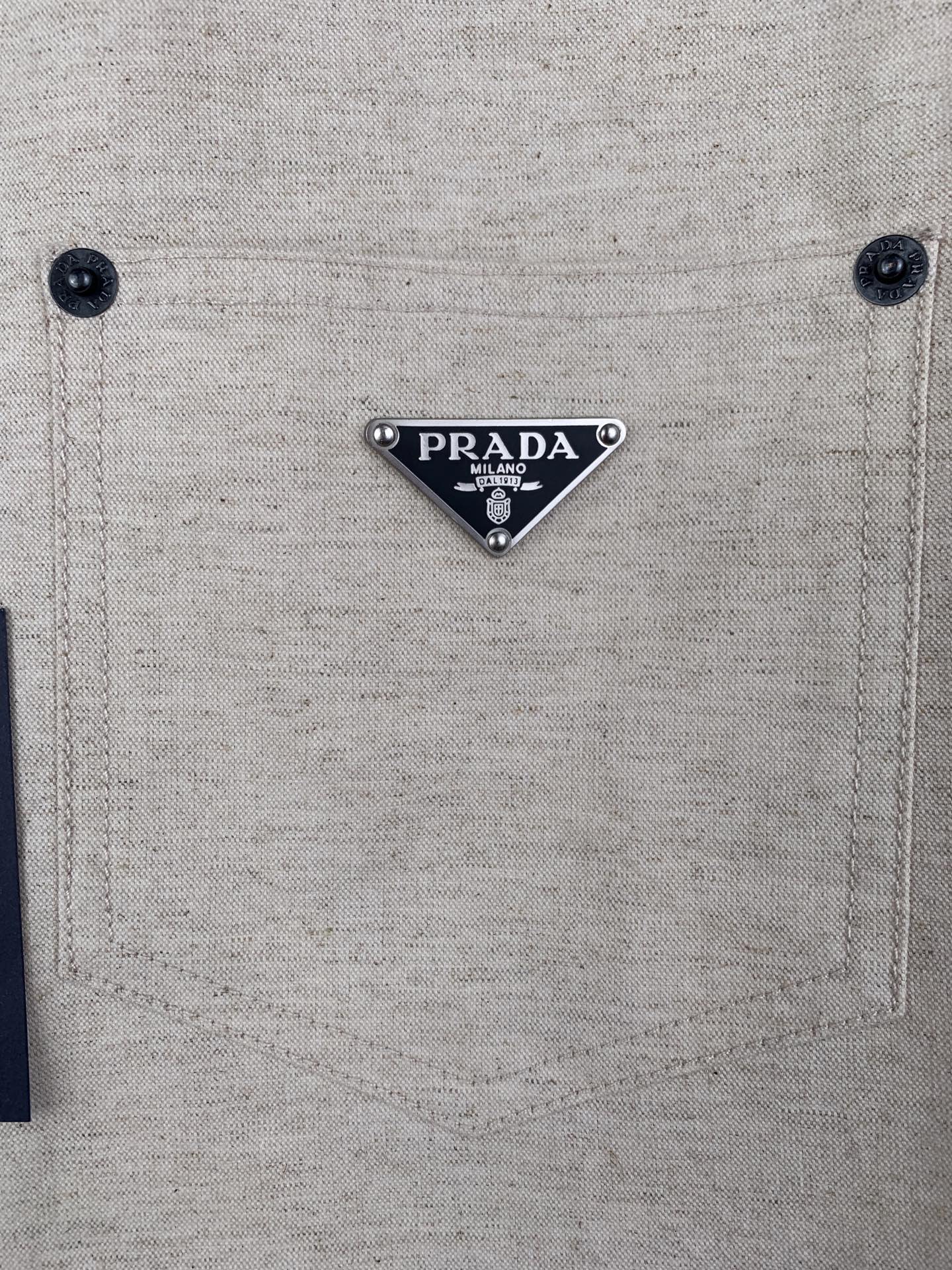 Beige shirt chest pocket with PRADA logo triangle patch and two buttons