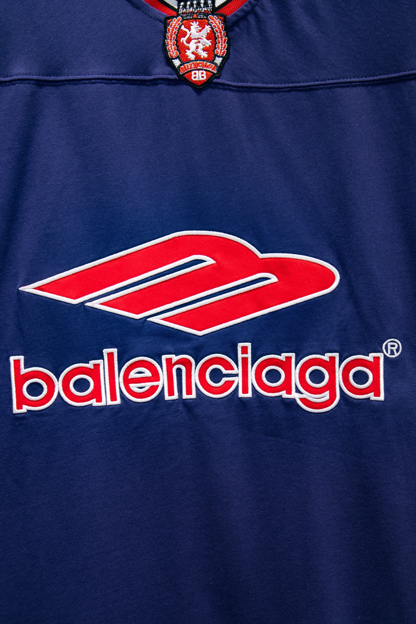 Balenciaga blue short-sleeve shirt with oversized Balenciaga logo and red swoosh