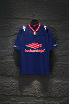 Balenciaga blue short-sleeve shirt with red-and-white striped collar and crest emblem