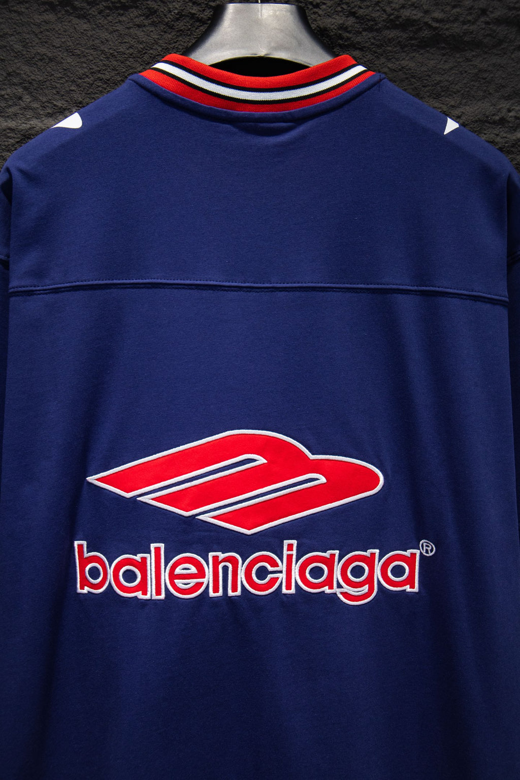 Balenciaga blue short-sleeve shirt front with red-and-white logo and striped collar