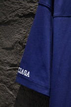 Balenciaga blue short-sleeve shirt side view with partial Balenciaga sleeve logo