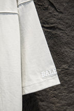 Balenciaga white T-shirt sleeve with blue logo print near cuff