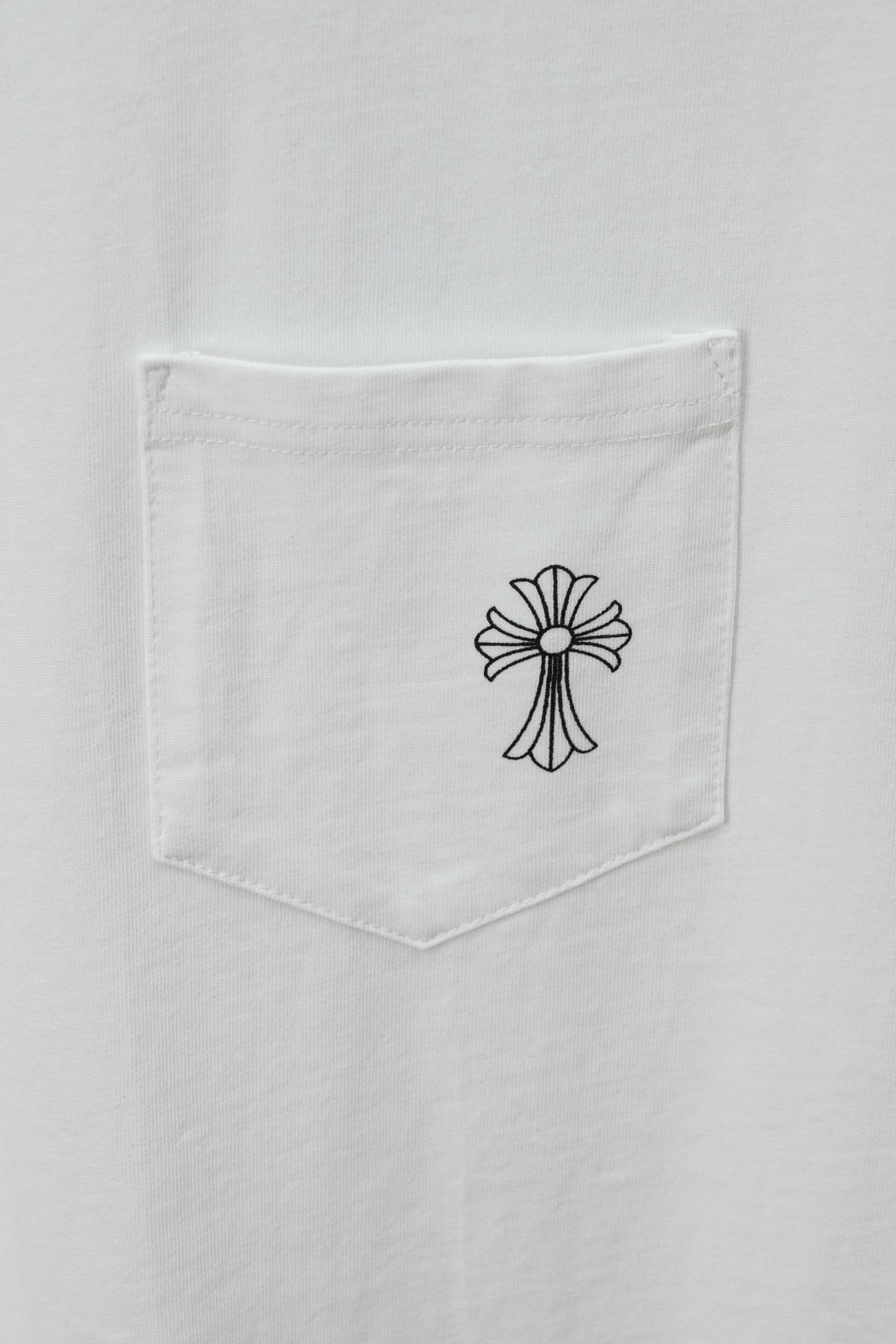 White T-shirt chest pocket with black cross-flower graphic