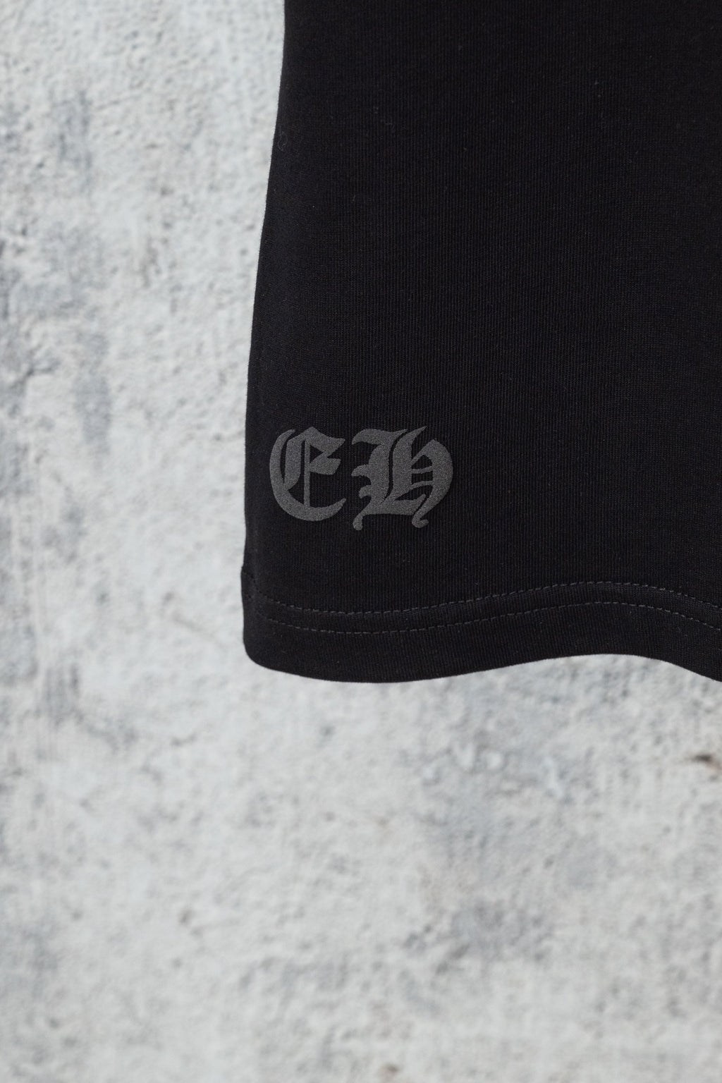 Black shorts hem with small embroidered logo near cuff