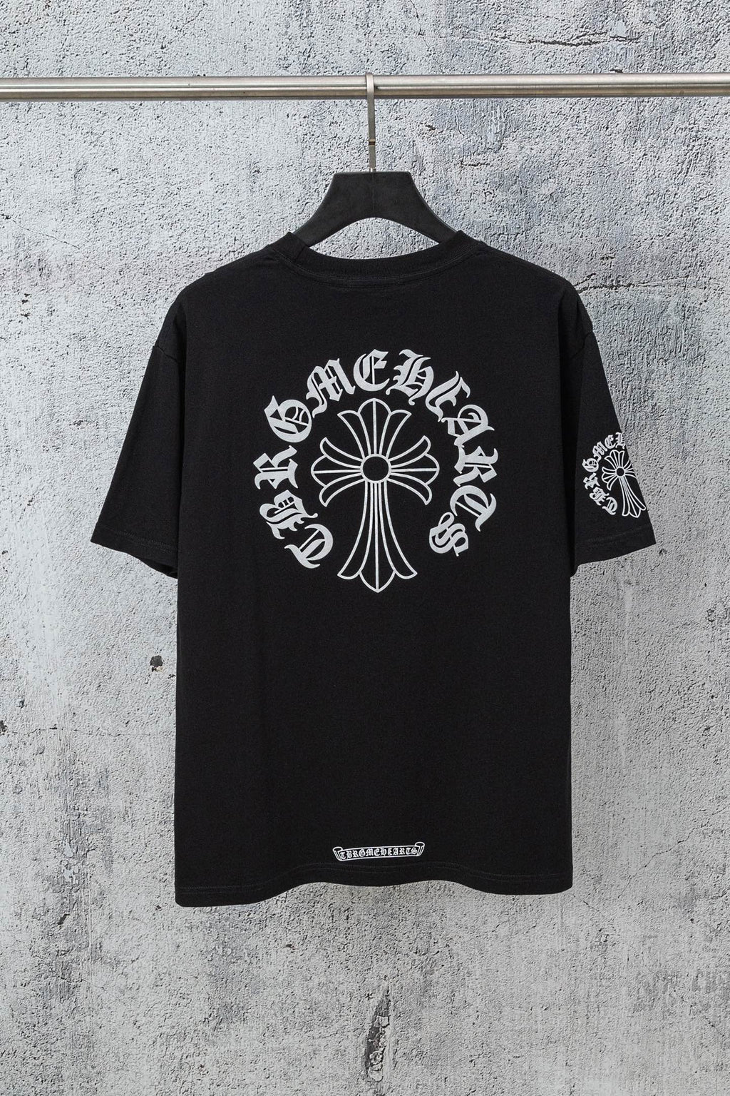 Black crew-neck T-shirt with large back cross-style graphic and small hem label