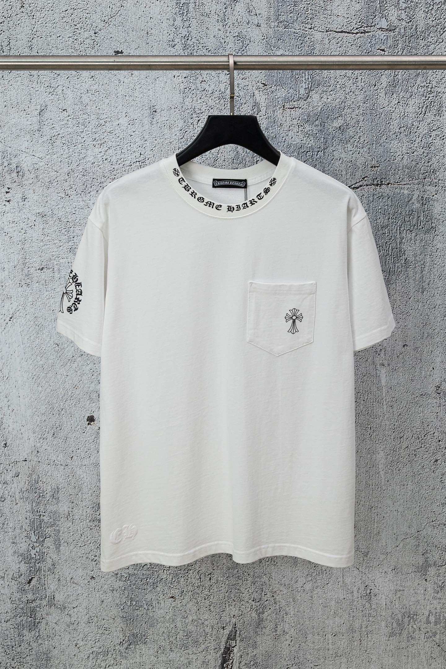 White crew-neck T-shirt with left chest pocket and cross-style graphic print