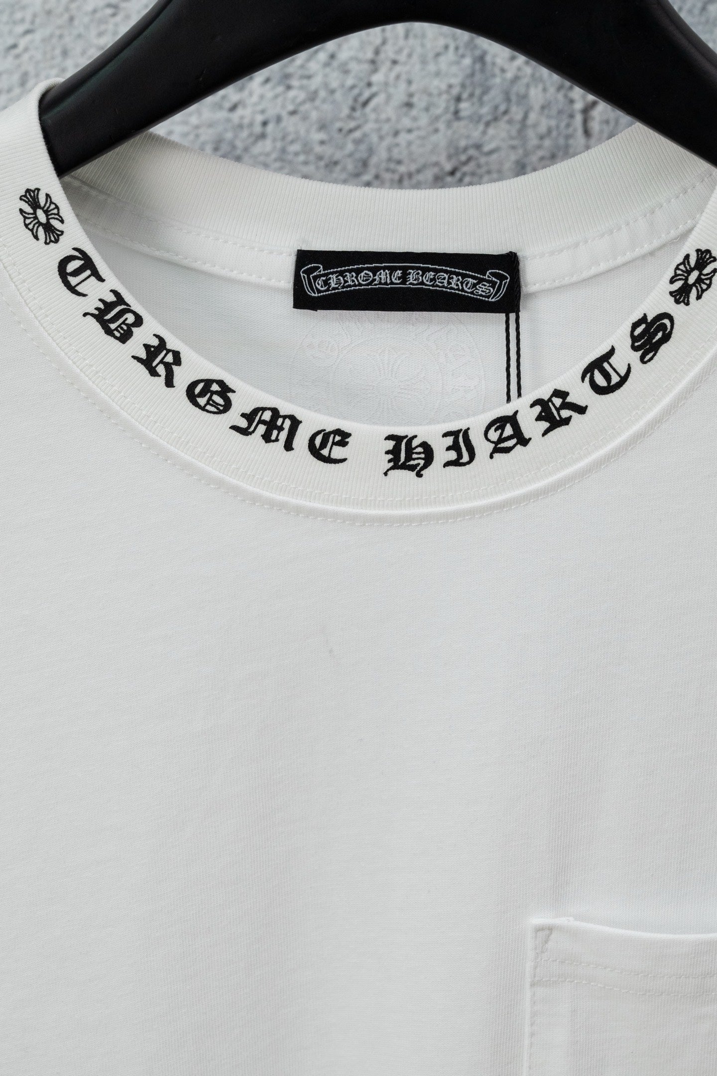 White crew-neck T-shirt neckline with black logo text band