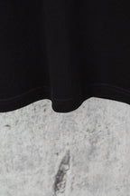 Black shorts lower hem with curved seam and stitching detail