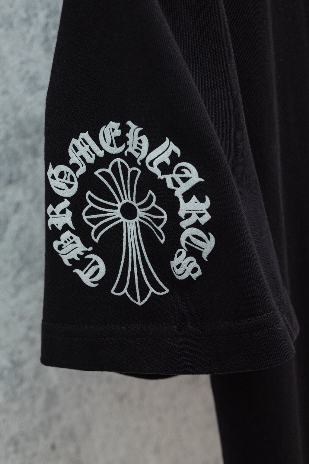 Black short-sleeve T-shirt with cross-style graphic print on chest