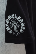Black T-shirt sleeve with large cross-flower graphic in white