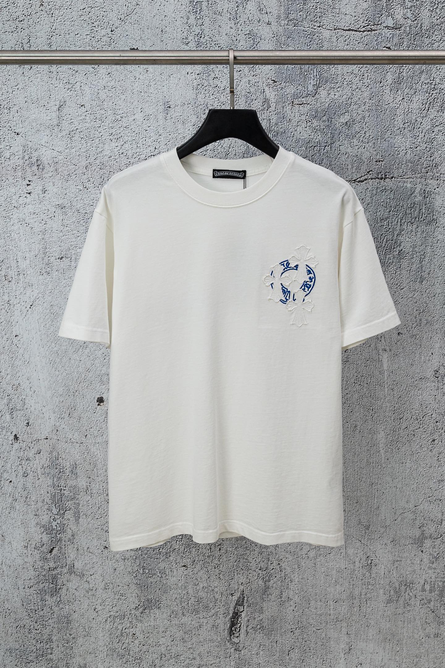 White graphic T-shirt with small blue chest logo and short-sleeve crew neck