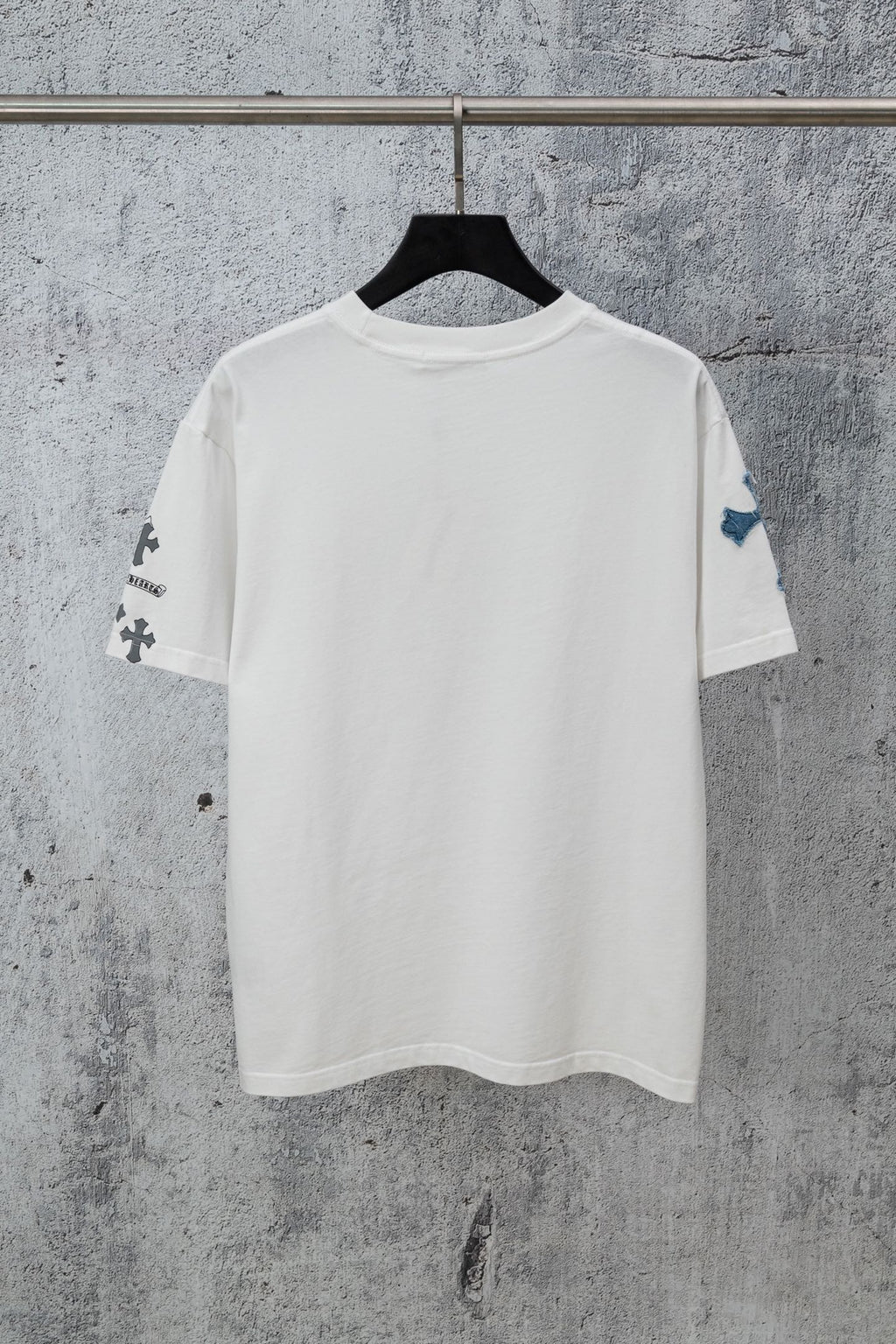White short-sleeve crew-neck T-shirt with small cross graphics on sleeves