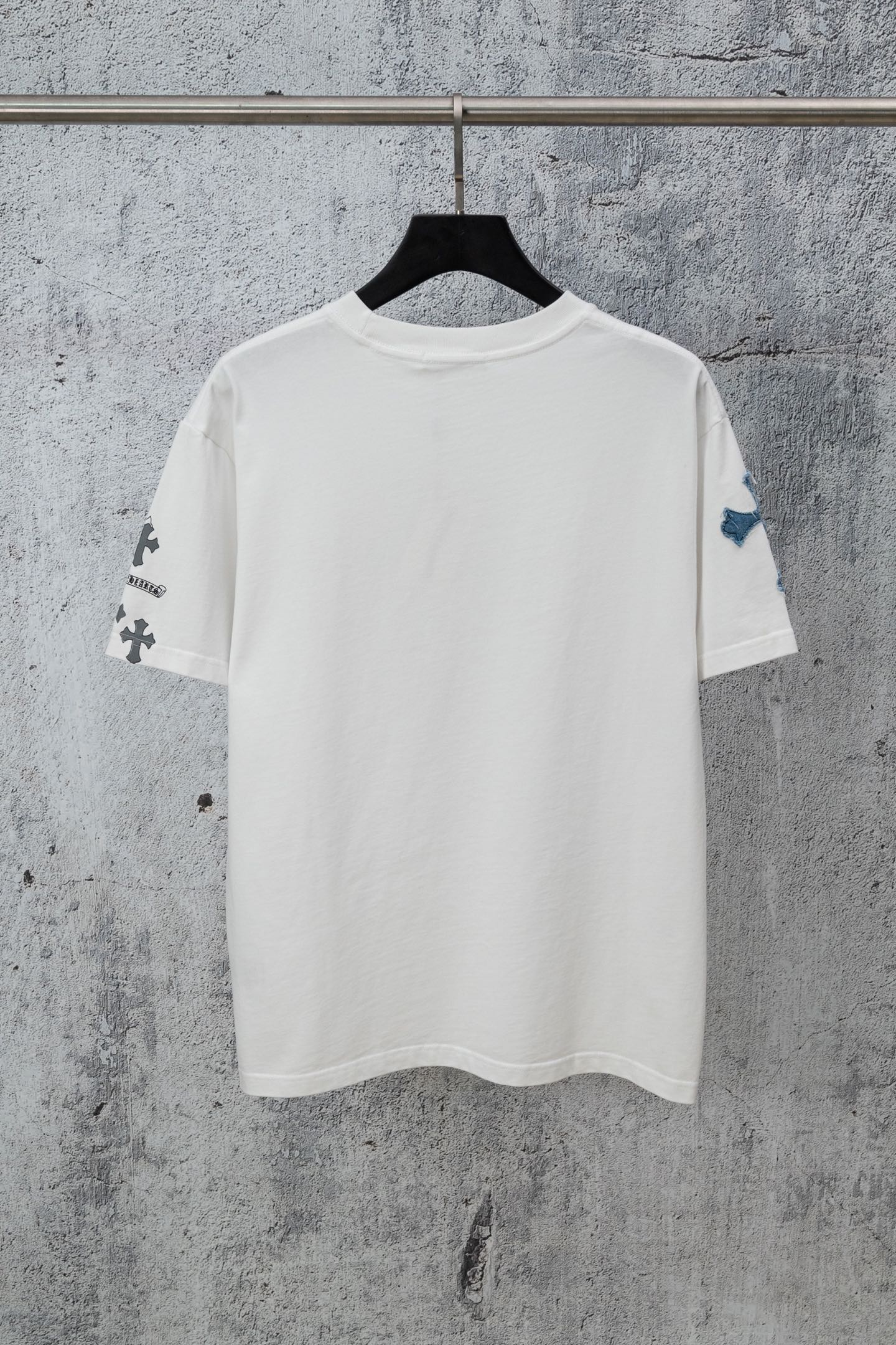 White short-sleeve crew-neck T-shirt with small cross graphics on sleeves