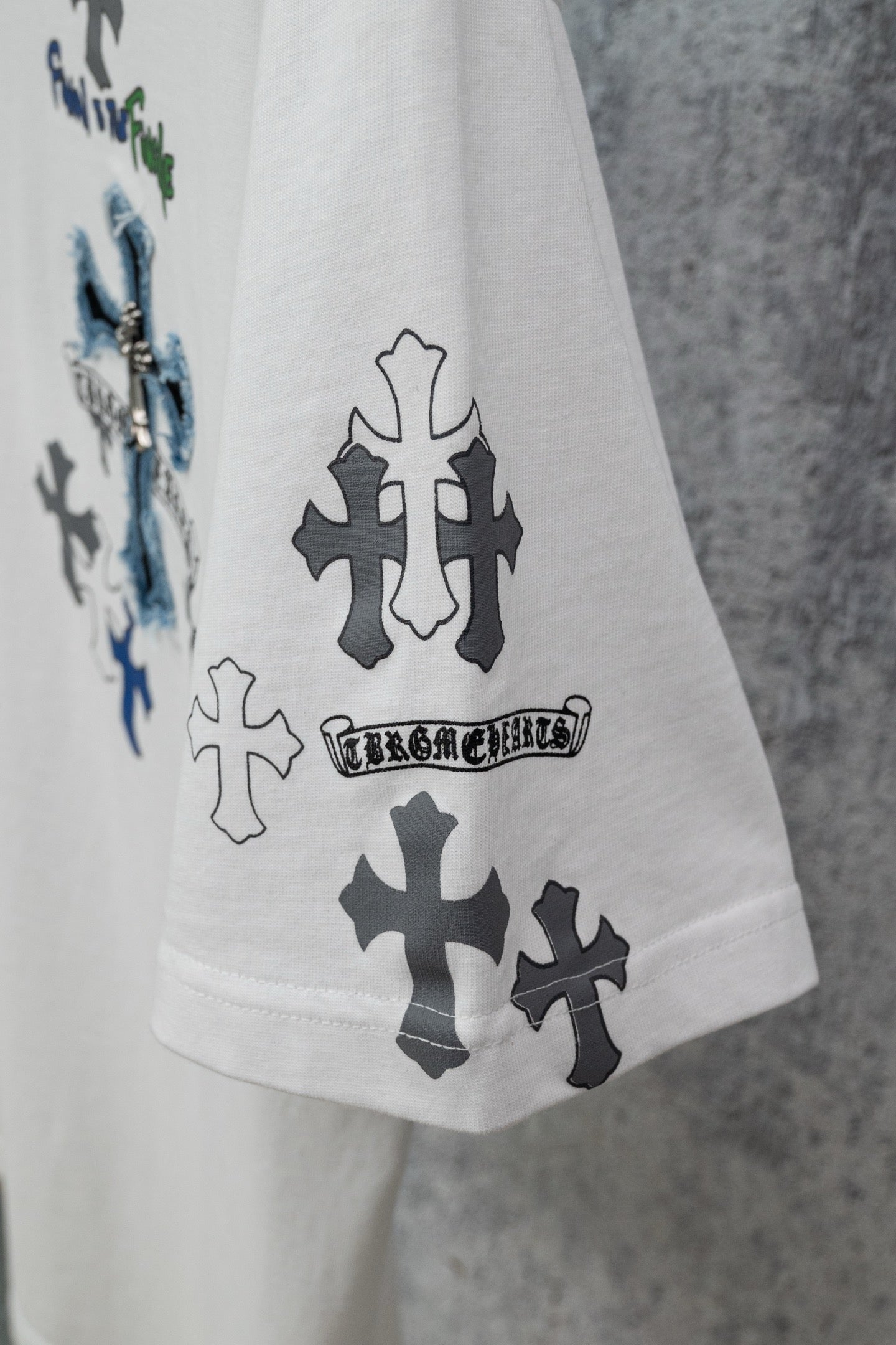 White crew-neck T-shirt with large cross prints on front and sleeve