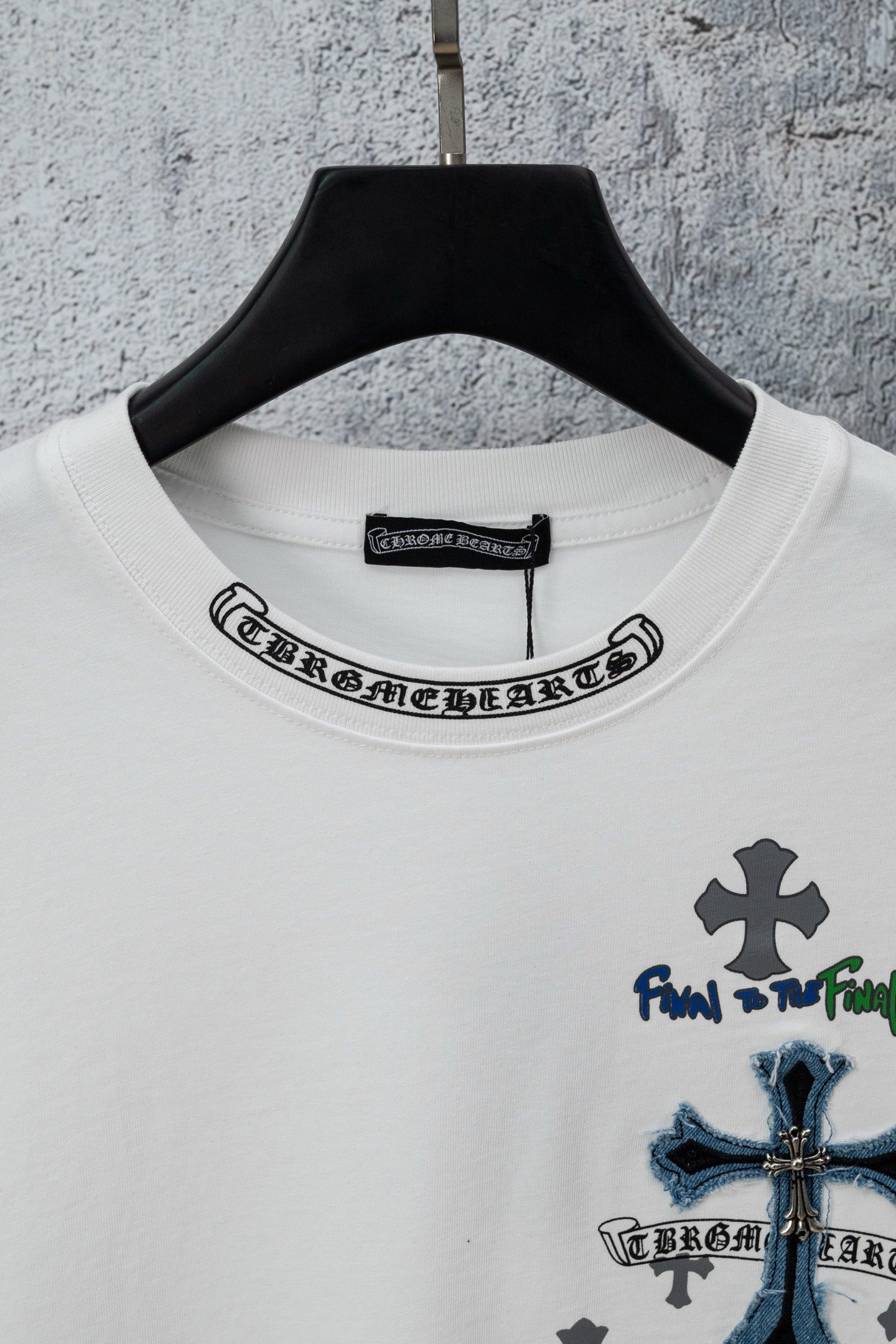 White crew-neck T-shirt with round collar logo and blue cross chest graphic