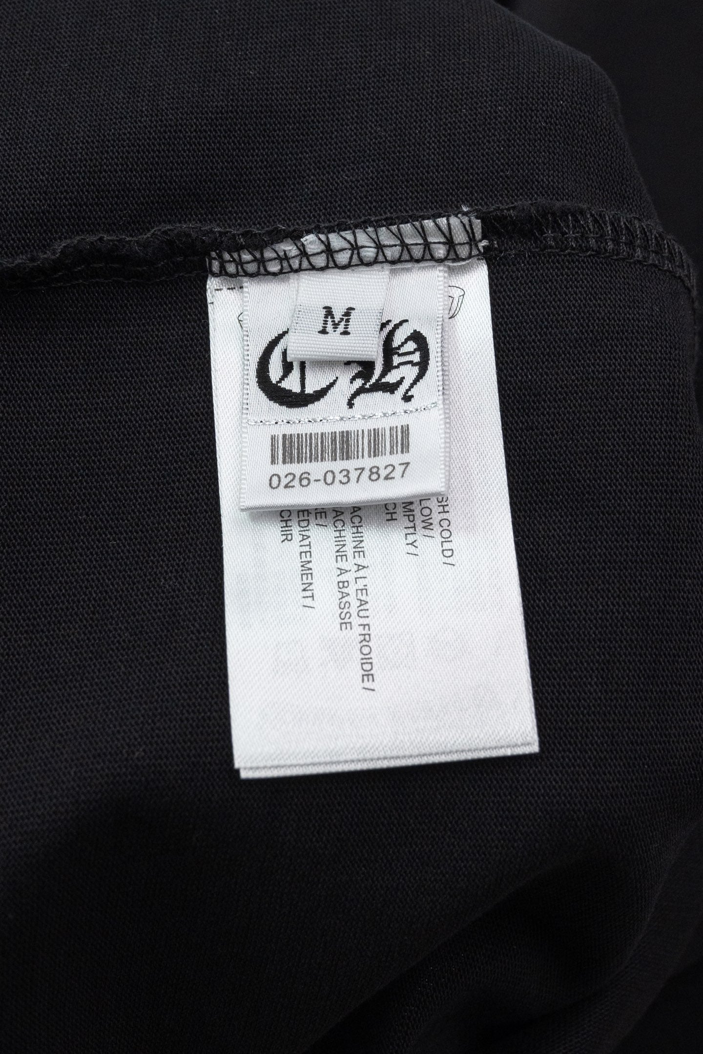 Black T-shirt fabric with woven size label inside neck