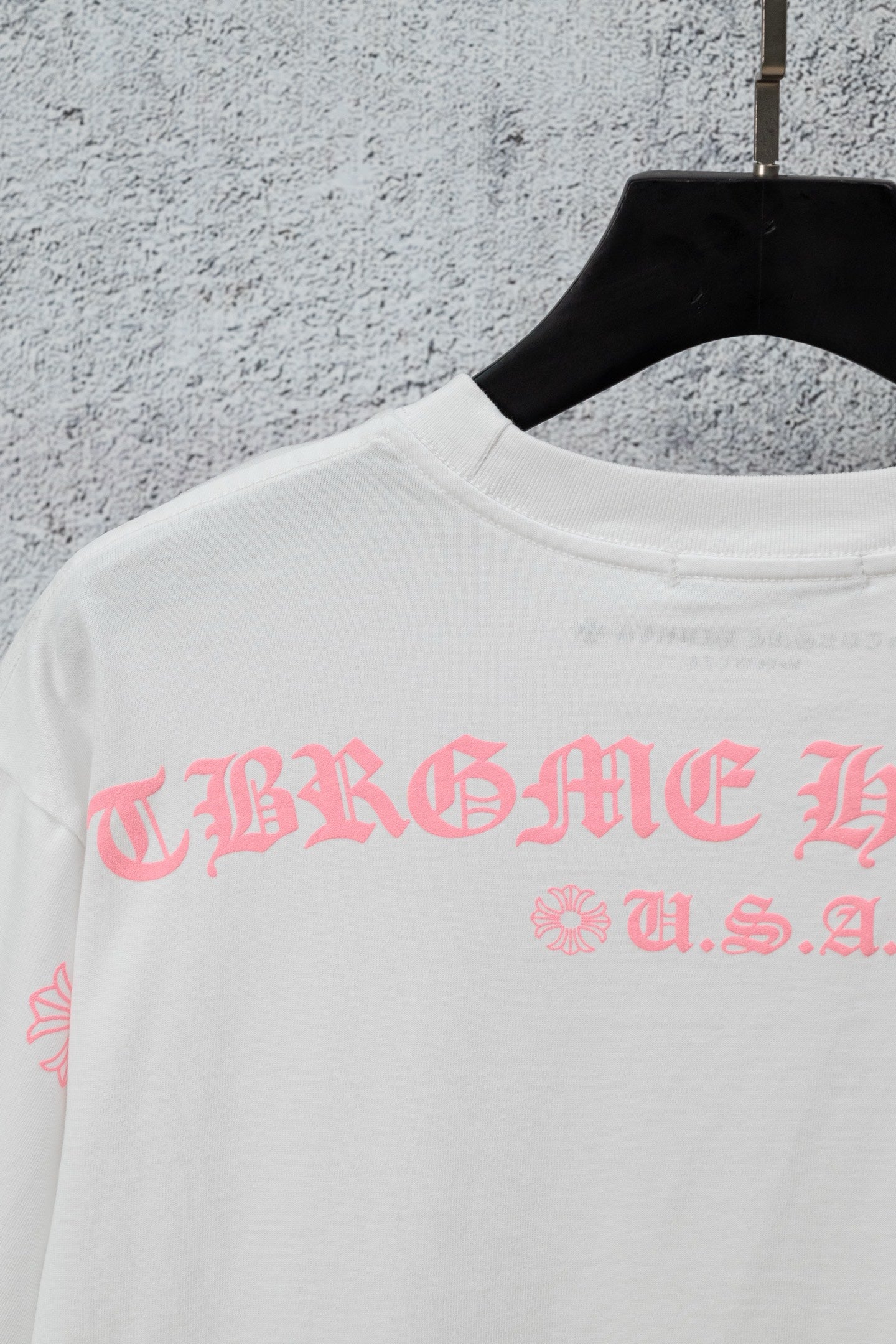 White short-sleeve T-shirt with pink graphic lettering across the chest