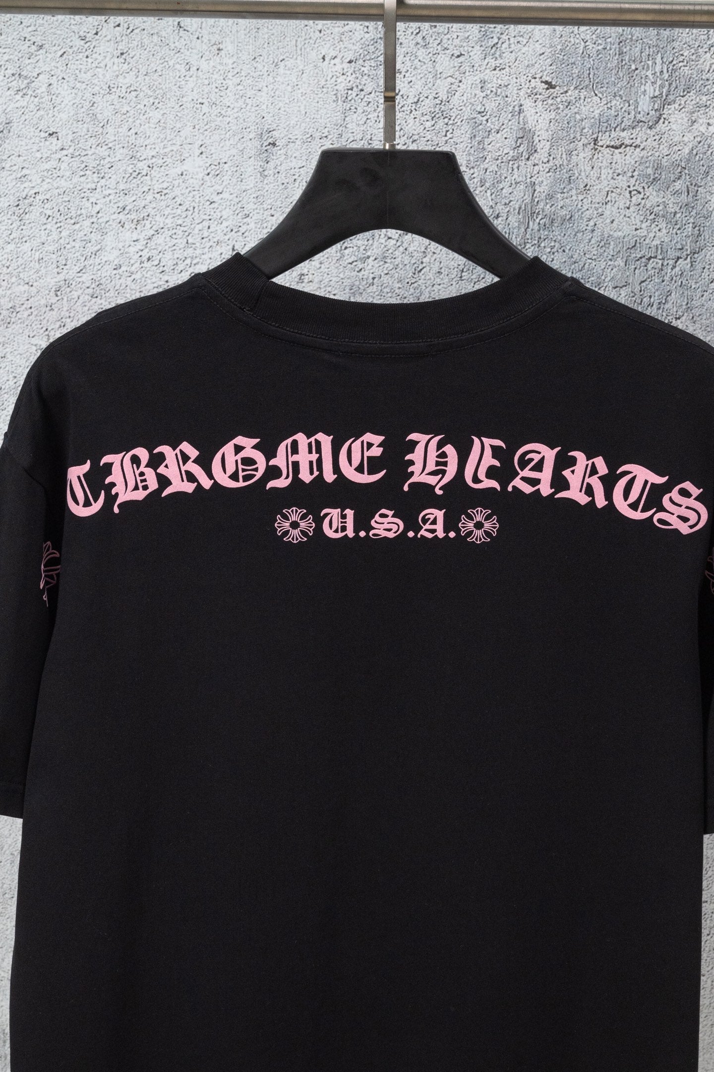 Black short-sleeve T-shirt with centered back graphic lettering and small print