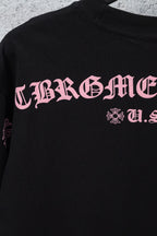 Black short-sleeve T-shirt with pink graphic lettering and small cross-flower emblem