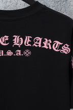 Black short-sleeve T-shirt with large pink front graphic lettering
