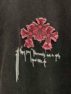 Short-sleeve T-shirt close-up of pink cross embroidery with white script details