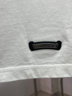 White T-shirt hem with black embroidered brand label and stitched bottom edge