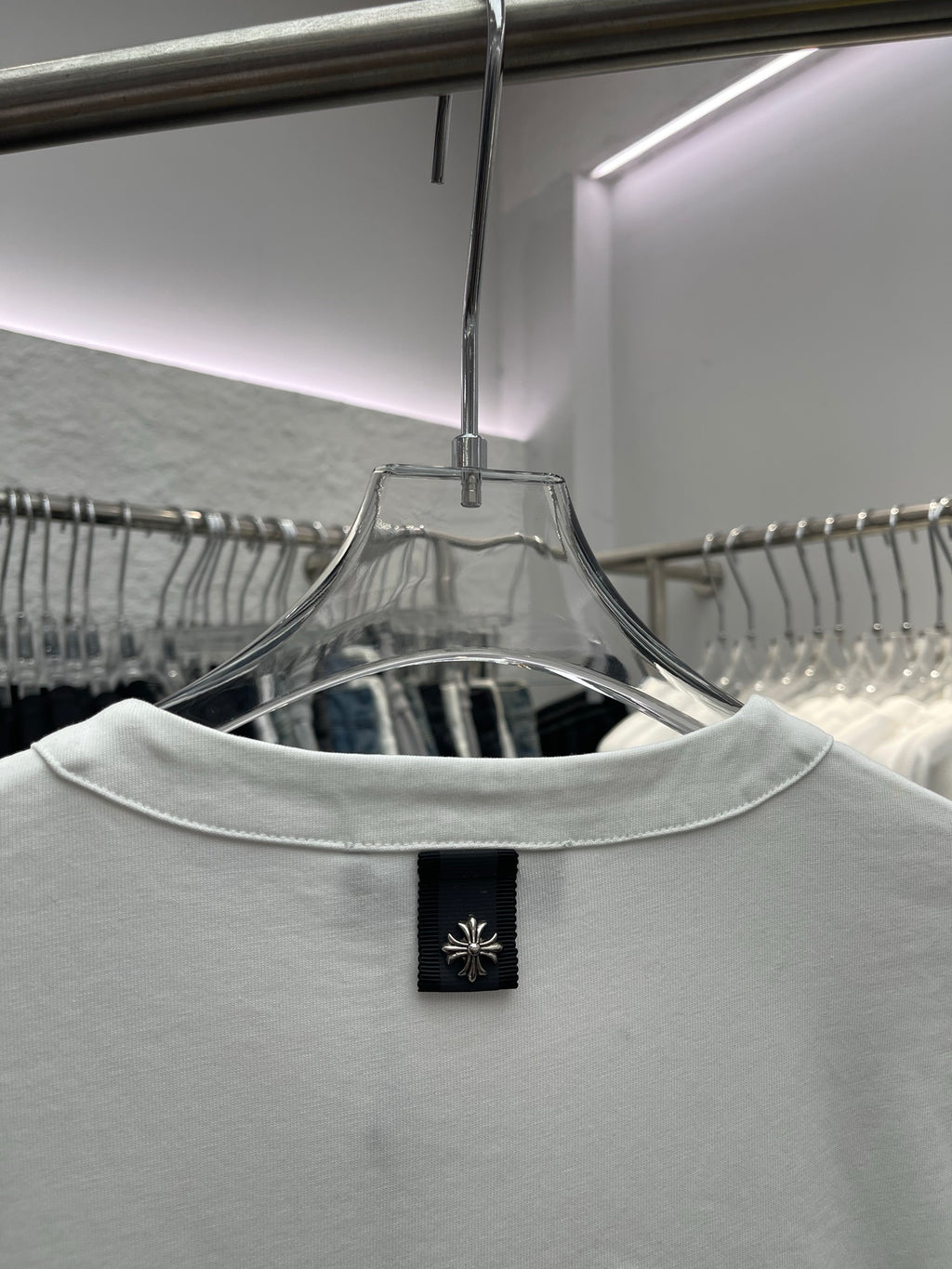 White T-shirt back neckline with black brand label on the collar
