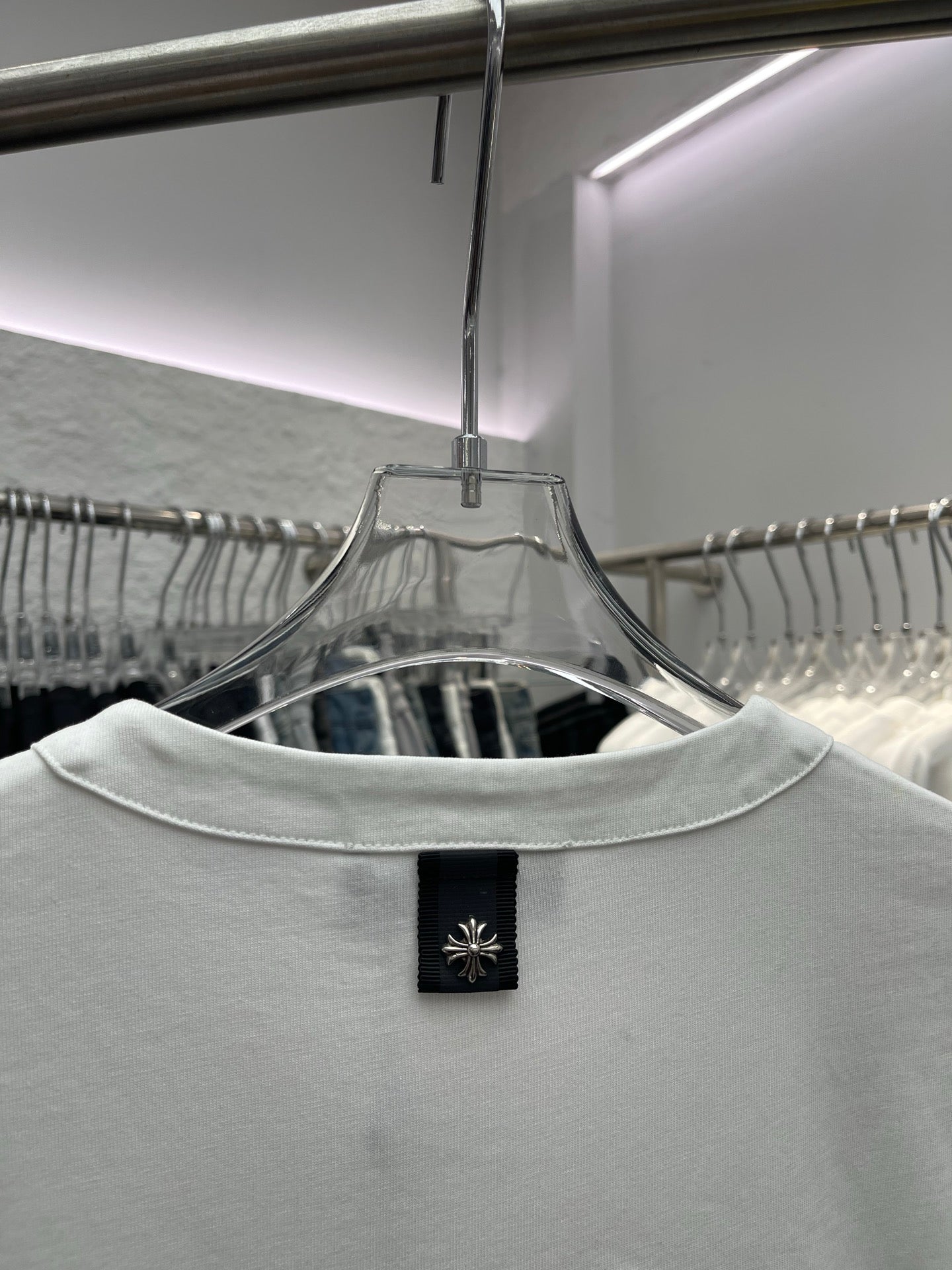 White T-shirt back neckline with black brand label on the collar