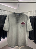 Light gray short-sleeve henley T-shirt with burgundy cross-and-script graphic