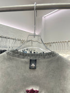 Light gray henley T-shirt neckline with collar buttons and burgundy print