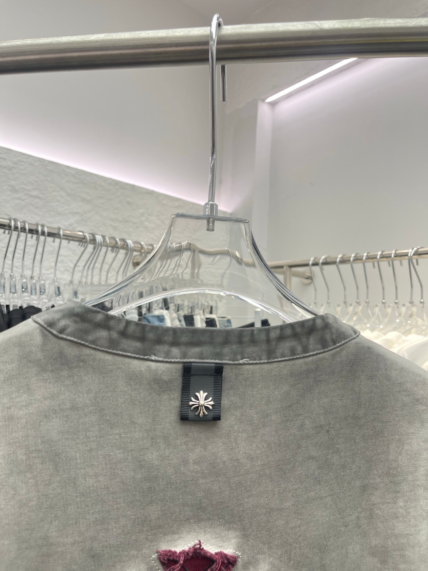 Light gray henley T-shirt neckline with collar buttons and burgundy print