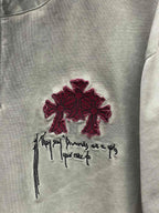Burgundy cross and script embroidery on a light gray T-shirt