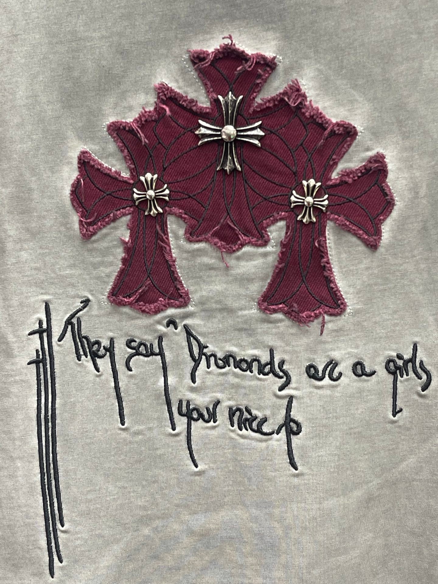 Burgundy cross embroidery with drips and script on a light gray T-shirt