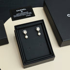 Chanel CC pearl drop stud earrings on black cushion in gift box