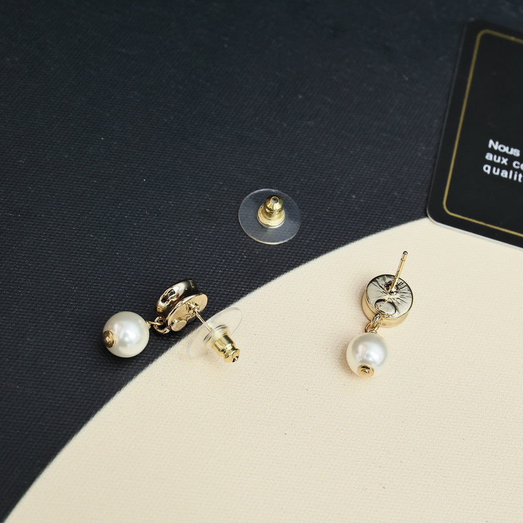 Gold-tone Chanel CC pearl drop earrings, close-up