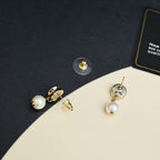 Gold-tone Chanel CC pearl drop earrings, close-up