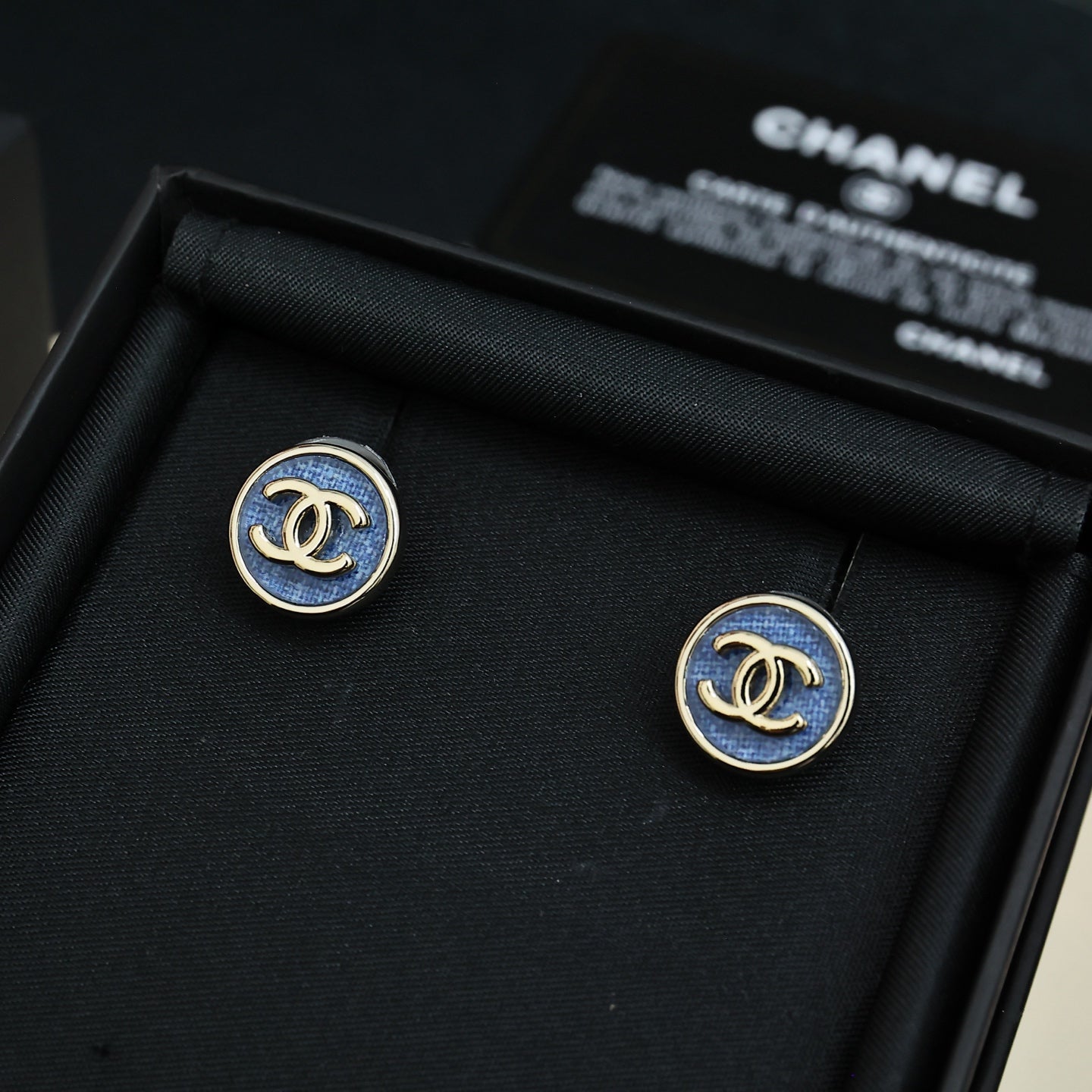 Chanel logo stud earrings with blue enamel in gold-tone circular settings