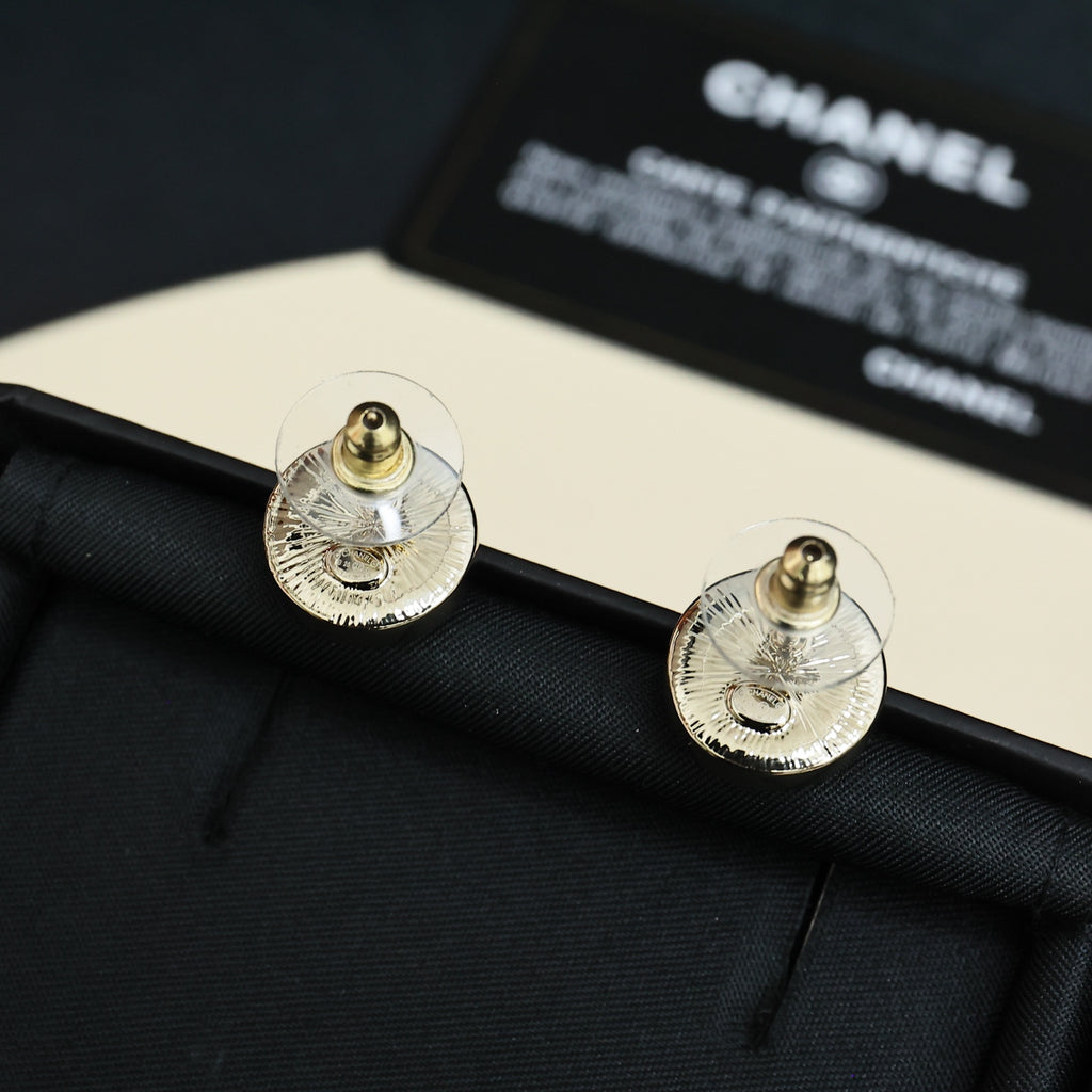 Chanel logo stud earrings with textured silver-tone backs and gold posts