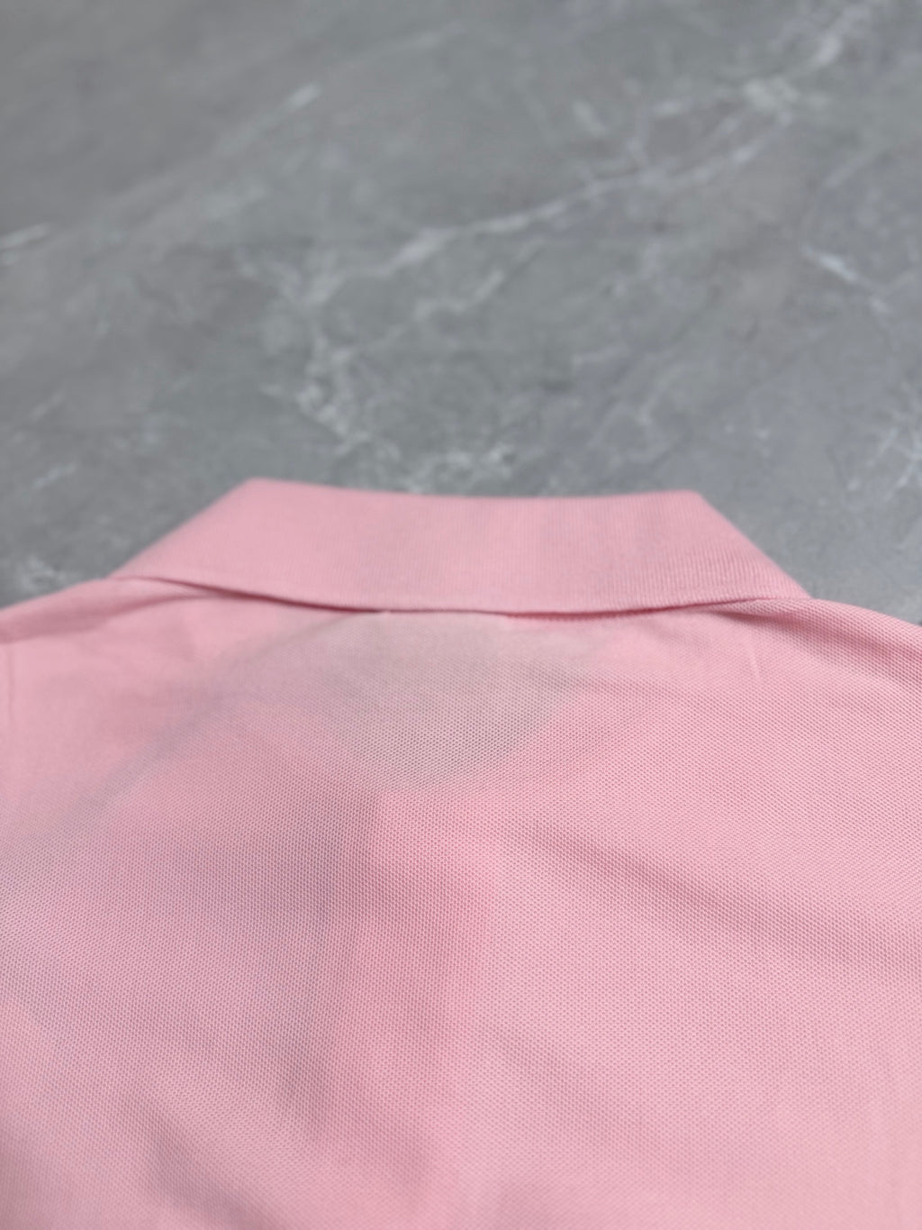Pink polo shirt back yoke area