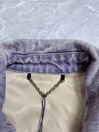 Louis Vuitton denim jacket neckline with chain and logo hang tag detail