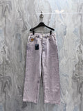 Light-wash Louis Vuitton denim pants with belt loops, front pockets, and button closure